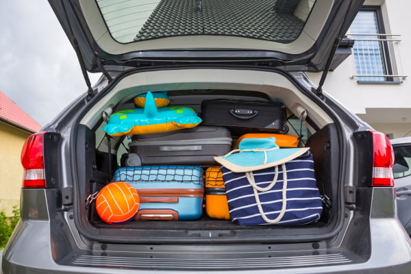 Back of a car packed for a summer road trip